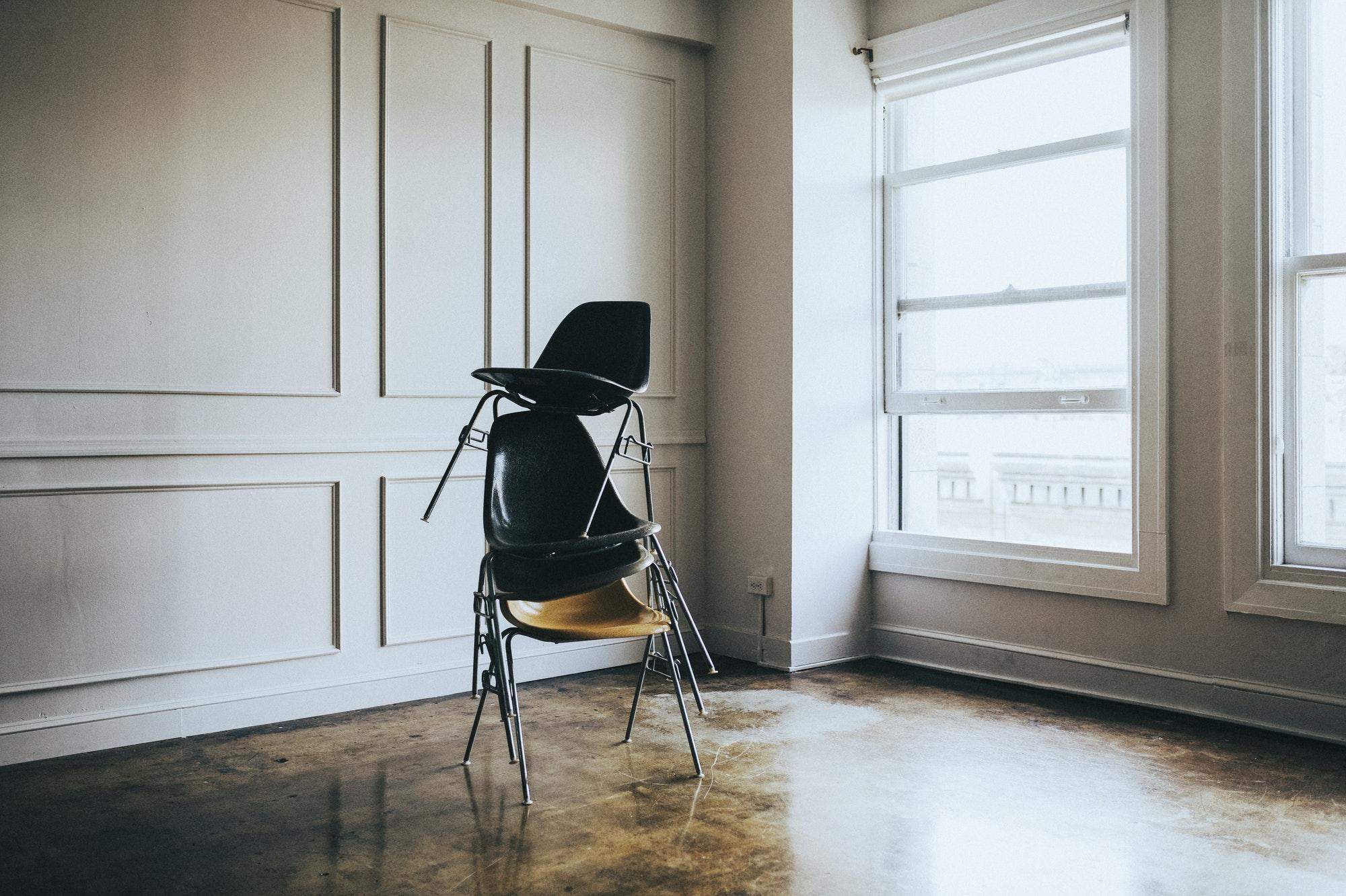 stacked-chairs-in-an-empty-room.jpg